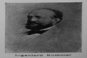 Ein Schwarz-Weiß-Foto eines bärtigen Mannes in einem Blazer und mit Brille, mit dem Text "Ingenlero Kummer, der Gründer der deutschen Revolution" unten.